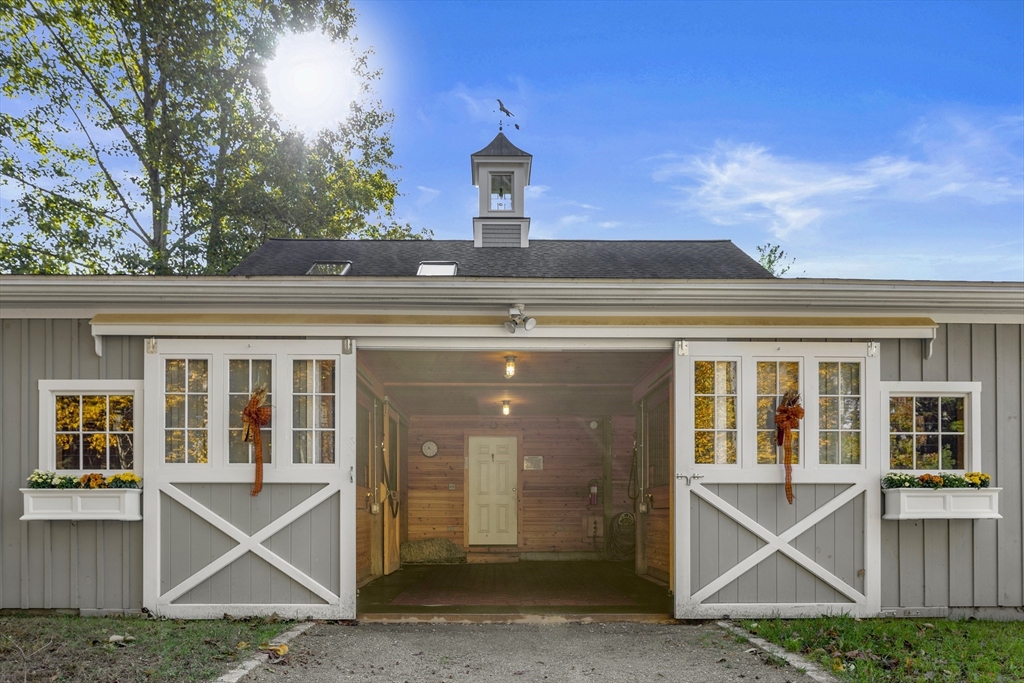 98 Valley Road Boxford, MA 01921 - Photo 29 of 40 a front view of a house with plants