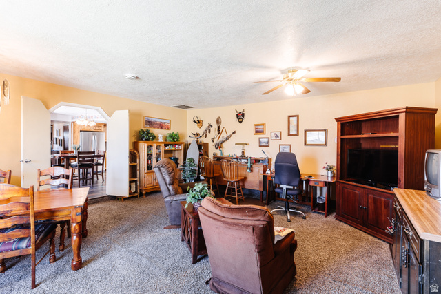 1470 Redwood Tree Street St. George, UT 84790 - Photo 21 of 53 Carpeted living area with light-toned walls and a ceiling fan