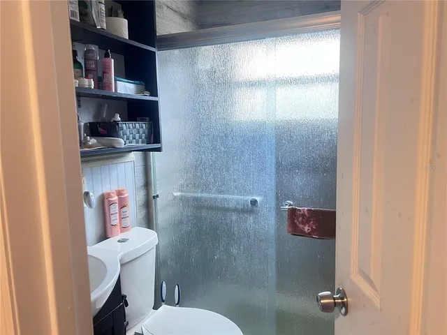 a bathroom with a toilet and a shower