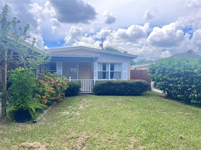 a view of a house with a garden and pathway