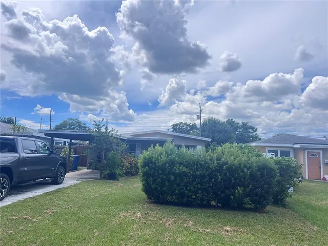a front view of a house with a garden and pathway