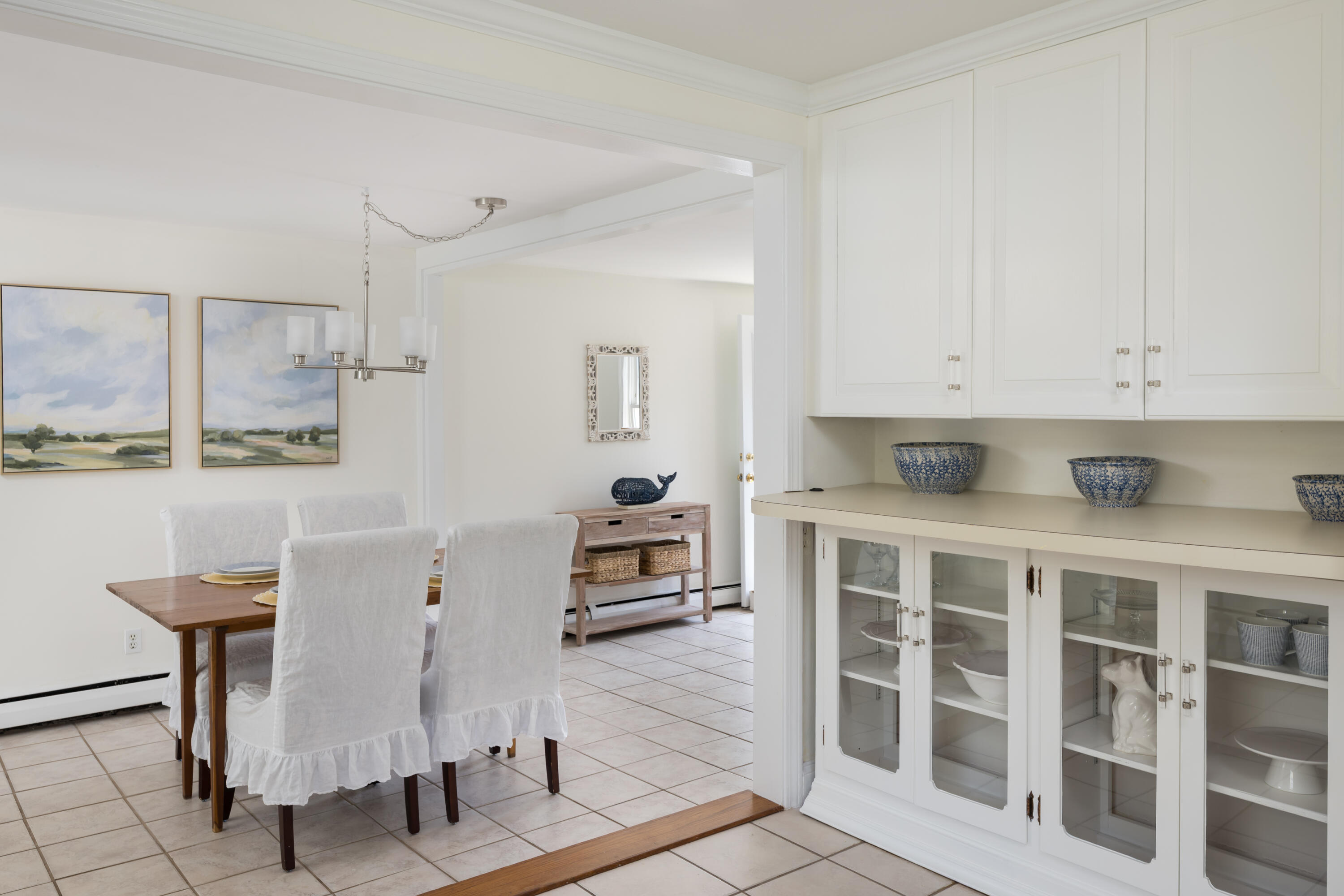 111 Lewis Road West Yarmouth, MA 02673 - Photo 14 of 43 a kitchen with a white cabinets and chairs