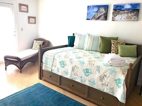 a bedroom with bed and wooden floor