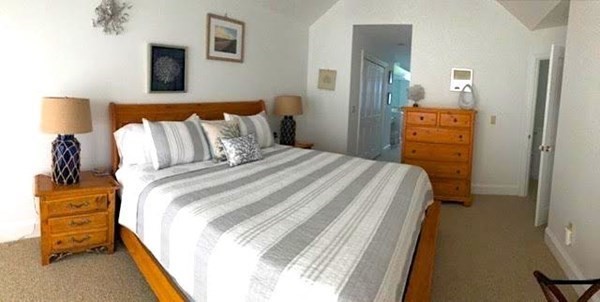 223 Sandpiper Lane Tisbury, MA 02568 - Photo 15 of 17 a bedroom with a bed and a night stand