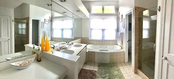 a bath room with a bath tub and a shower