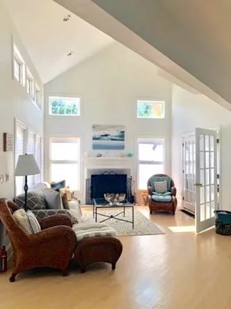 a living room with furniture fireplace and a window