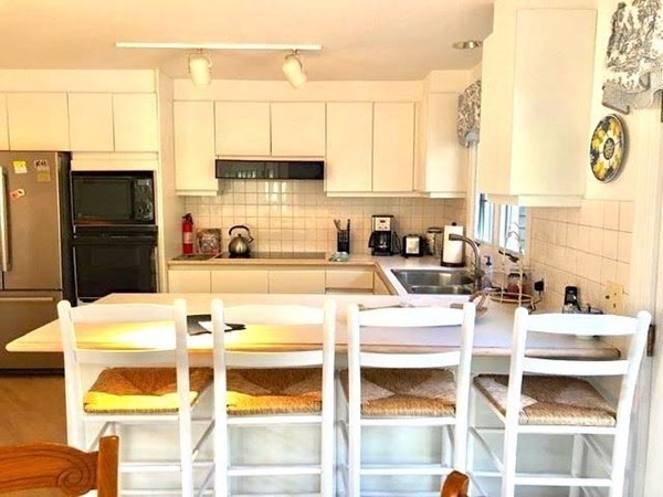 223 Sandpiper Lane Tisbury, MA 02568 - Photo 5 of 17 a kitchen with stainless steel appliances kitchen island granite countertop a sink and cabinets