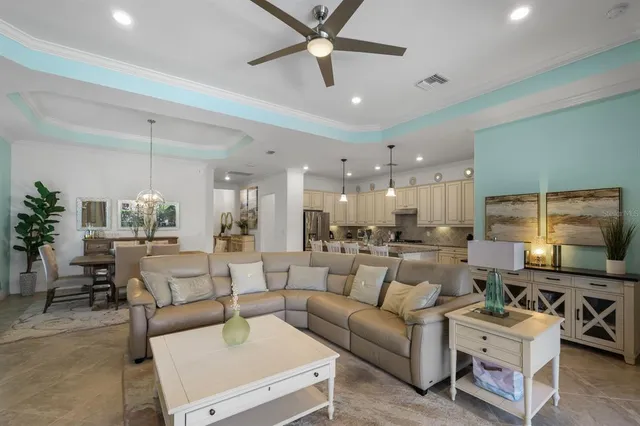 a bedroom with a bed wooden floor and a ceiling fan