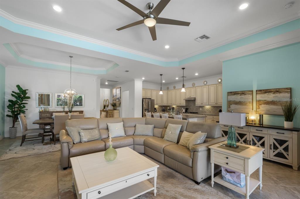 6036 Cessna Run Bradenton, FL 34211 - Photo 15 of 75 a living room with furniture kitchen view and a chandelier