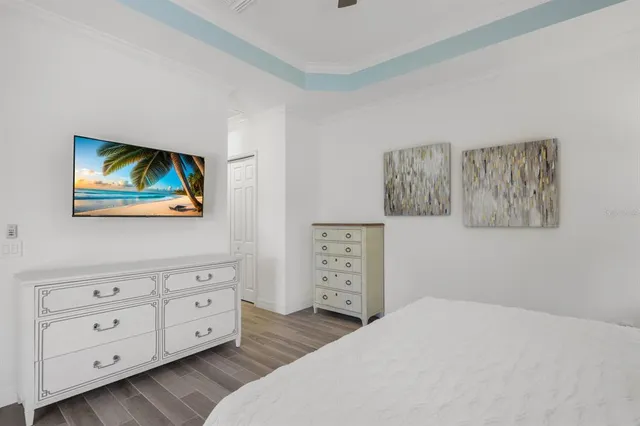 a bathroom with a granite countertop double vanity sink a mirror and a bathtub
