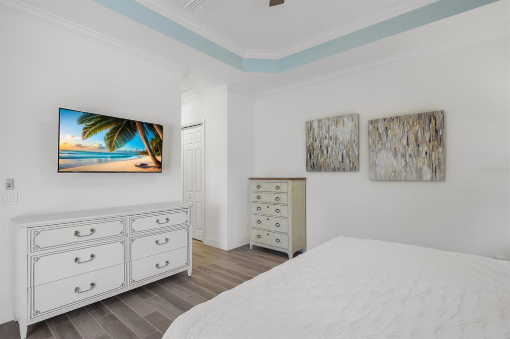 6036 Cessna Run Bradenton, FL 34211 - Photo 19 of 75 a bedroom with a bed and a dresser in it