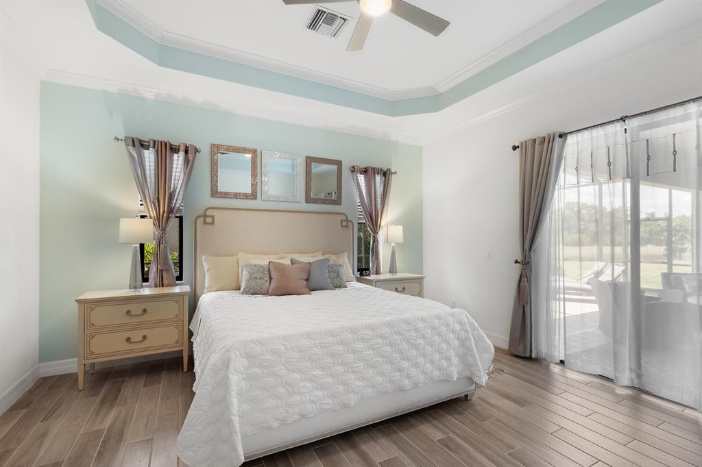 6036 Cessna Run Bradenton, FL 34211 - Photo 20 of 75 a bedroom with a bed and a large window with wooden floor