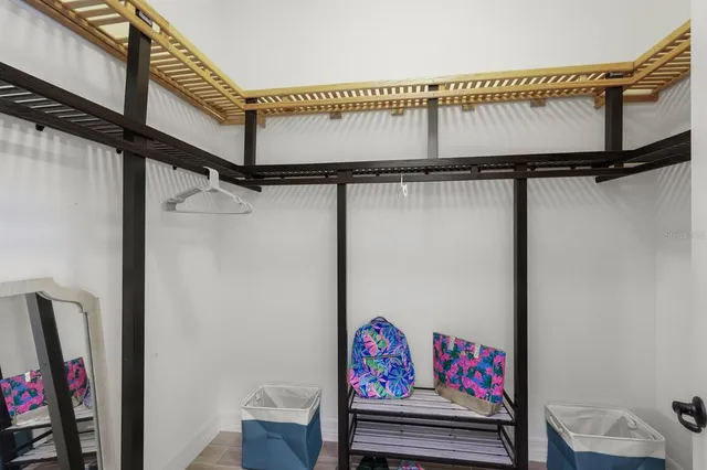 a bedroom with a bed and a flat tv screen on dresser