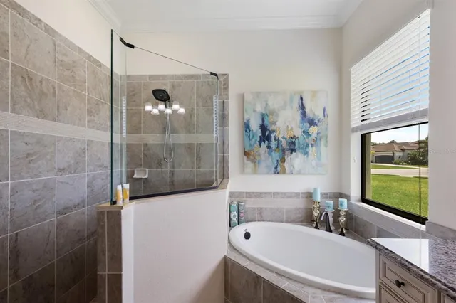 a bathroom with a granite countertop sink toilet mirror and shower