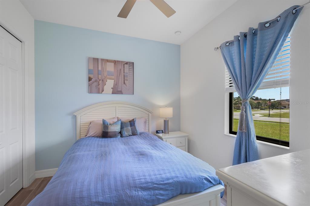 6036 Cessna Run Bradenton, FL 34211 - Photo 30 of 75 a bedroom with a large bed and a chandelier