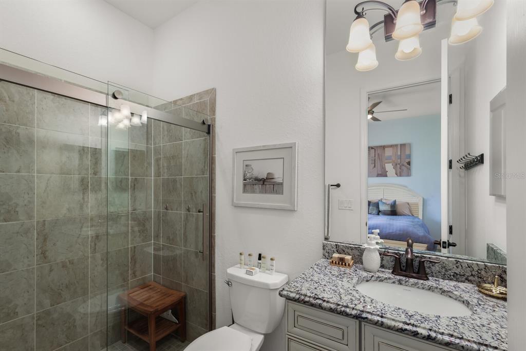 6036 Cessna Run Bradenton, FL 34211 - Photo 31 of 75 a bathroom with a granite countertop sink toilet and shower