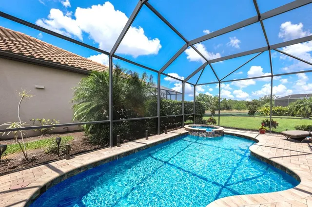 a very nice looking living room with furniture and floor to ceiling windows