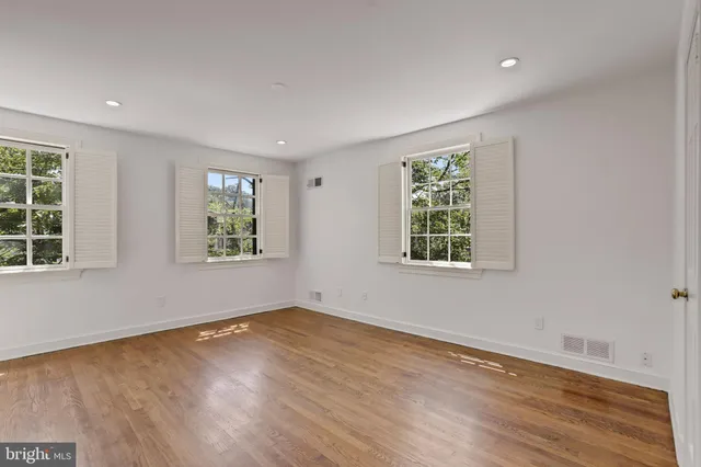 a bathroom with a sink and mirror with shower