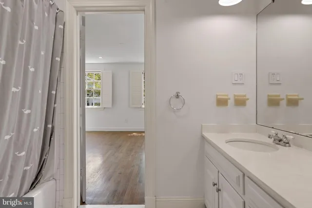 a bathroom with a granite countertop sink mirror and double