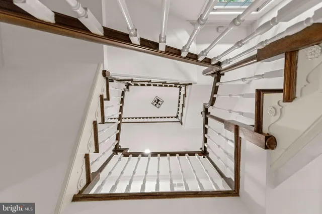 a view of empty room with wooden floor and fireplace