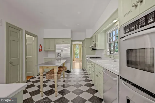 a kitchen with stainless steel appliances a sink and cabinets