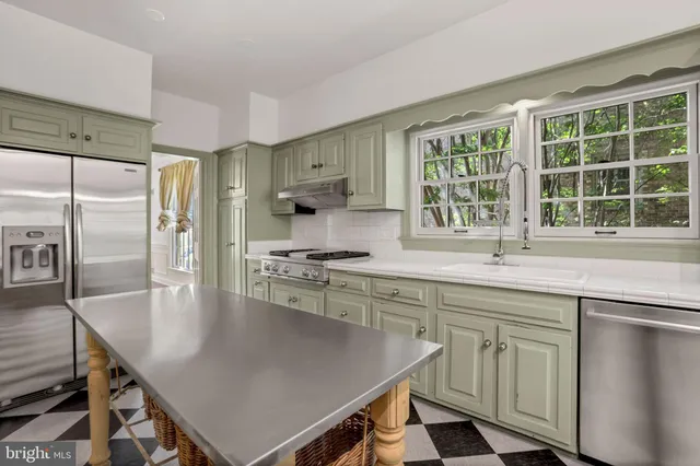 a kitchen with center island and stainless steel appliances
