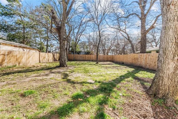 a view of a yard with large trees