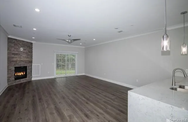 a view of an empty room with a fireplace and a window