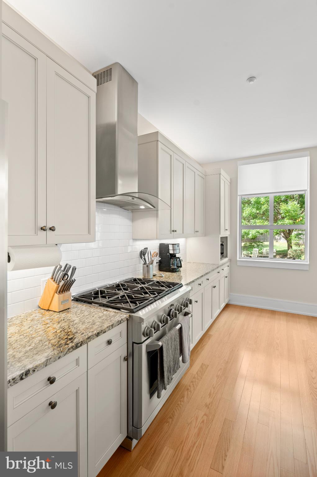 112 Iron Works Way Wayne, PA 19087 - Photo 23 of 50 a kitchen with stainless steel appliances granite countertop a stove a sink and white cabinets
