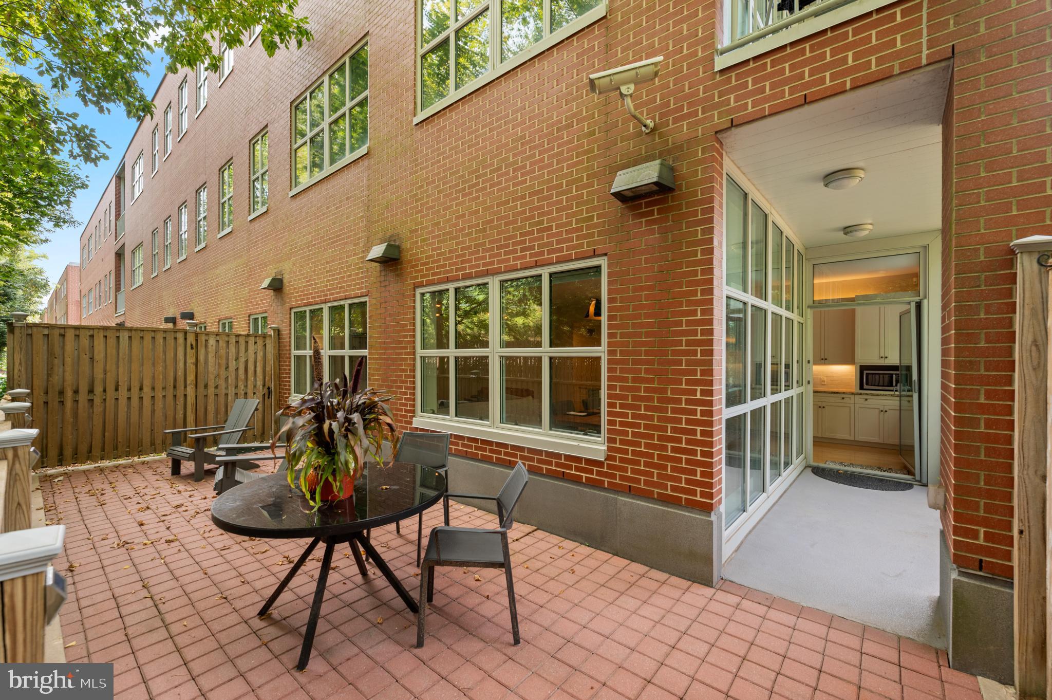 112 Iron Works Way Wayne, PA 19087 - Photo 28 of 50 a patio with table and chairs and potted plants