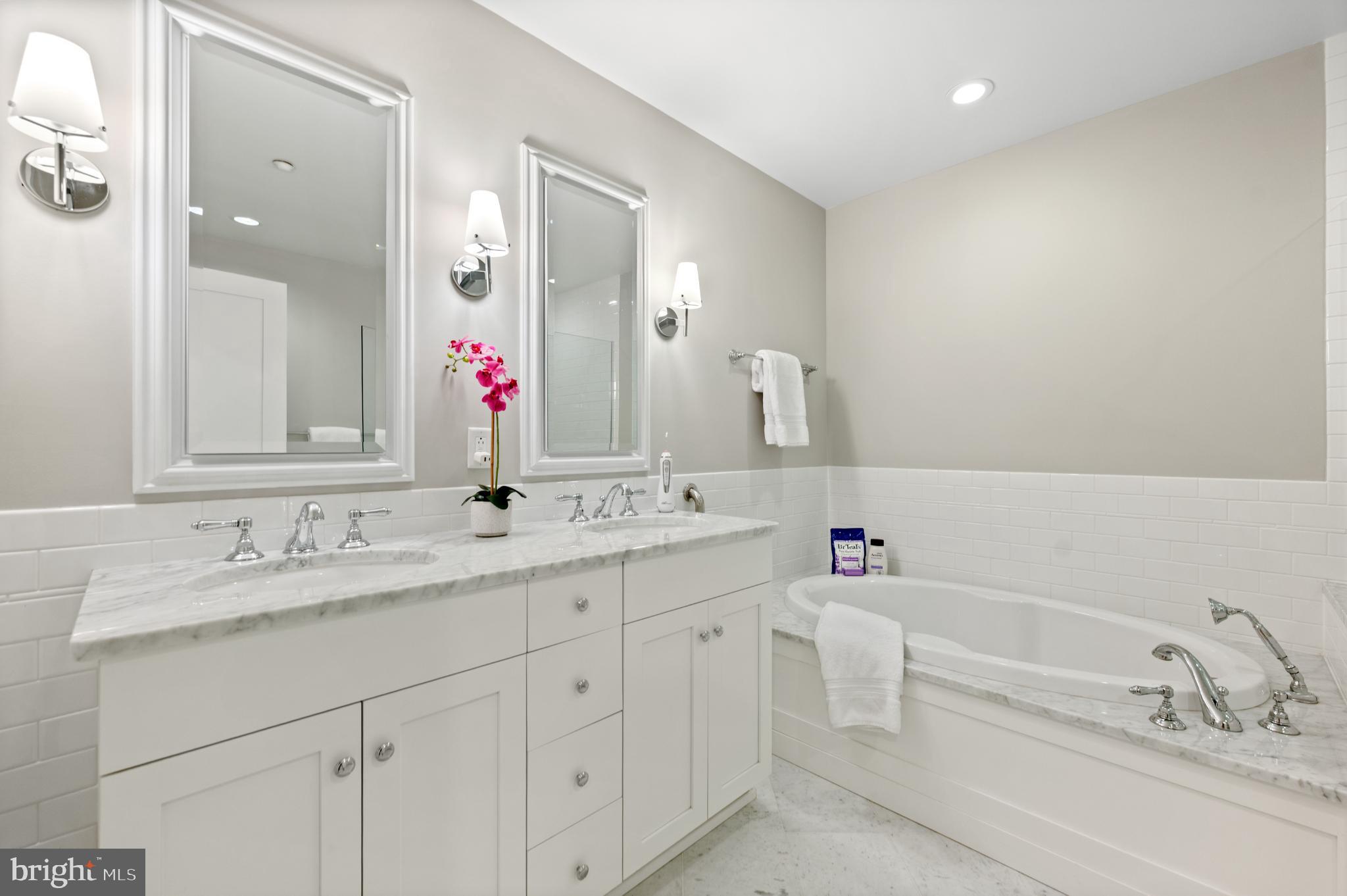 112 Iron Works Way Wayne, PA 19087 - Photo 40 of 50 a bathroom with a bathtub sink double vanity and mirror