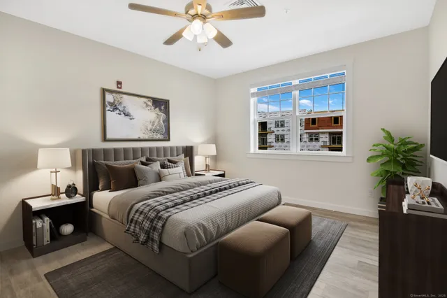 a bedroom with bed and a window