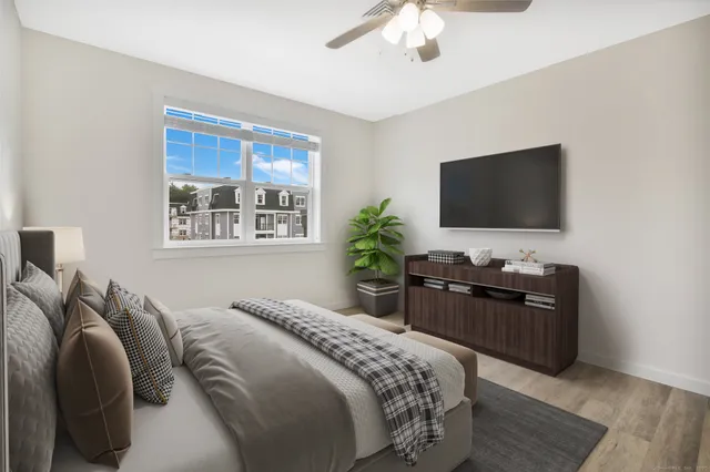 a bedroom with a bed and a flat screen tv