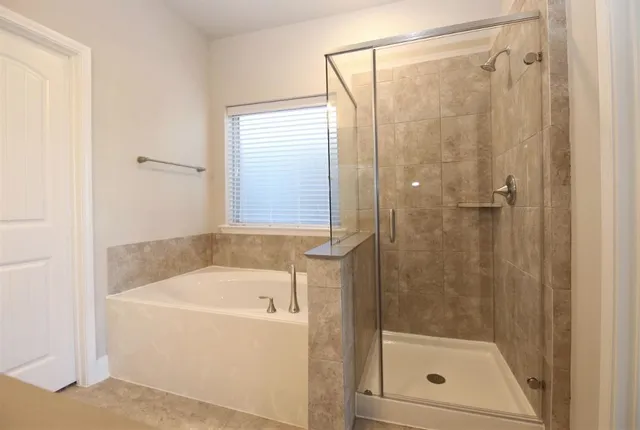 a white bath tub sitting next to a shower