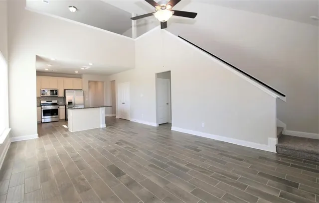 a view of kitchen with refrigerator microwave and wooden floor