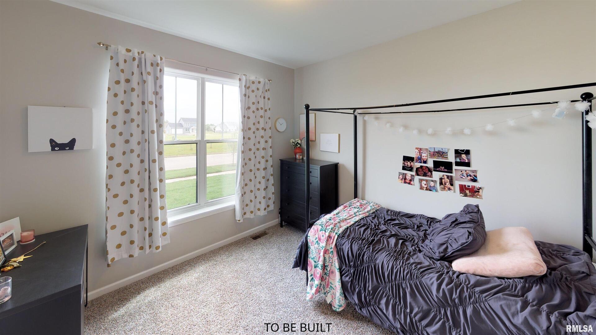 6 South 5th Street Eldridge, IA 52748 - Photo 11 of 17 a bedroom with a bed and a window