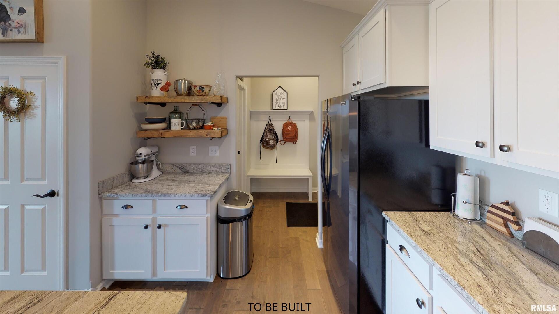 6 South 5th Street Eldridge, IA 52748 - Photo 6 of 17 a kitchen with stainless steel appliances granite countertop a refrigerator and a stove
