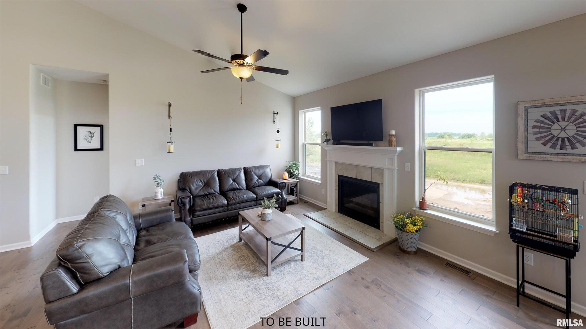 6 South 5th Street Eldridge, IA 52748 - Photo 7 of 17 a living room with furniture a flat screen tv and a fireplace