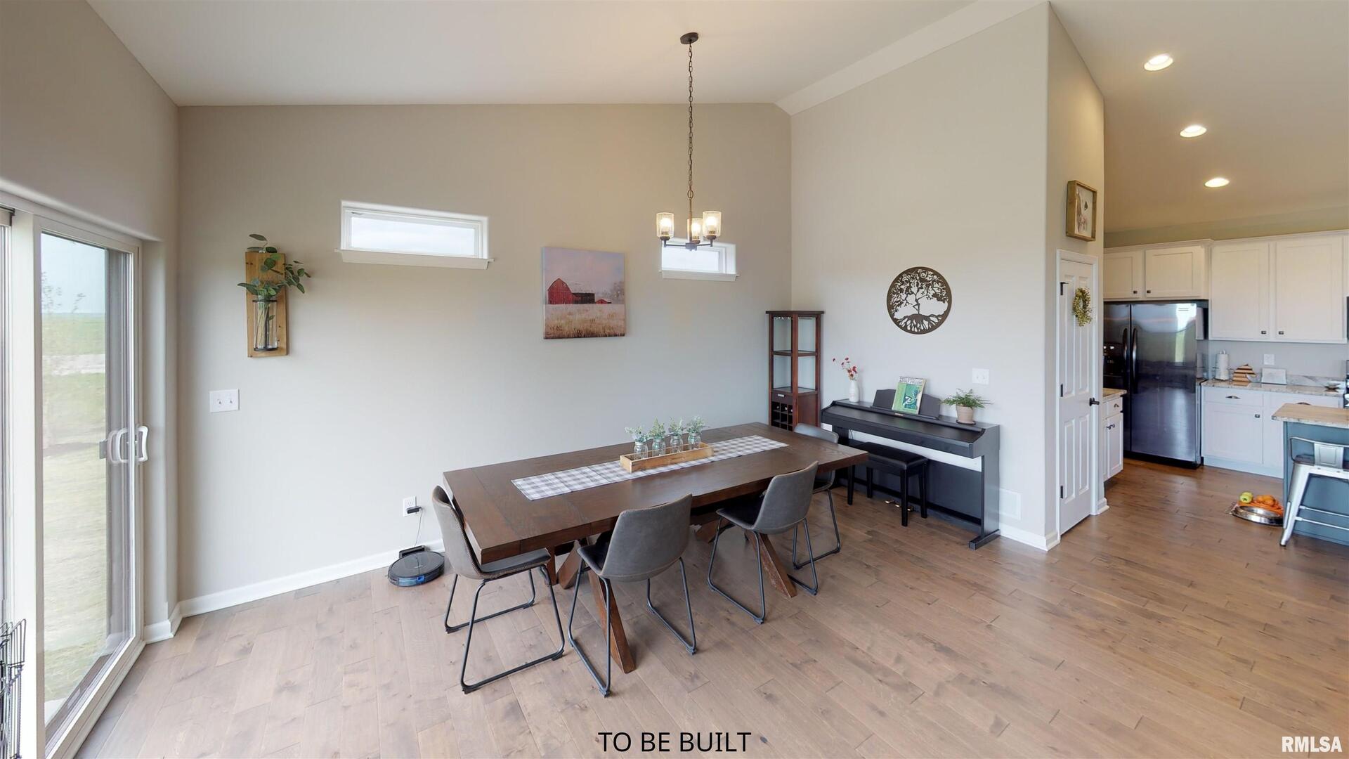 6 South 5th Street Eldridge, IA 52748 - Photo 10 of 17 a view of a kitchen and a dining room with furniture window and wooden floor