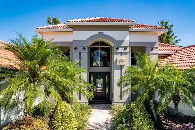 a view of a small house with potted plants