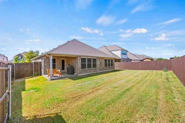 a view of a swimming pool with a lawn chairs under an umbrella