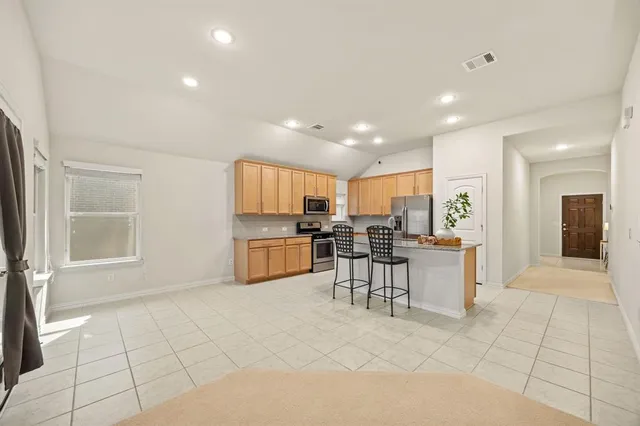 a view of kitchen with furniture and a refrigerator