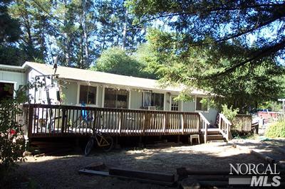 18050 Blattner Road Philo, CA 95466 - Photo 2 of 3 a porch with a bench next to a yard
