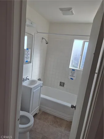 a bathroom with a granite countertop toilet a sink and bathtub
