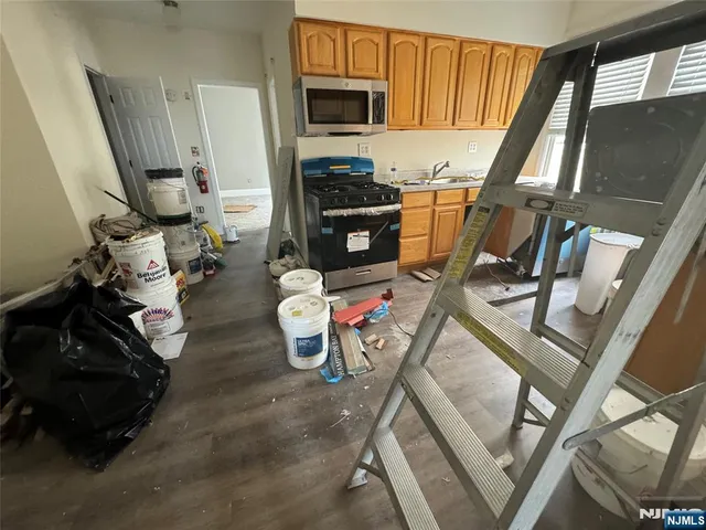 a view of a kitchen with furniture and flat screen tv