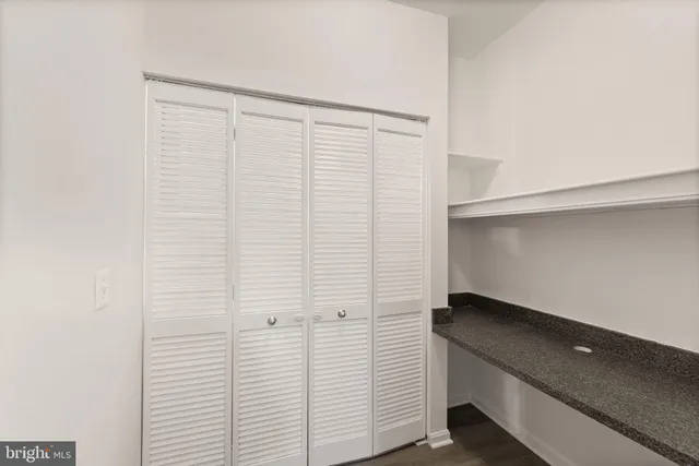 a room with a bench and cabinets