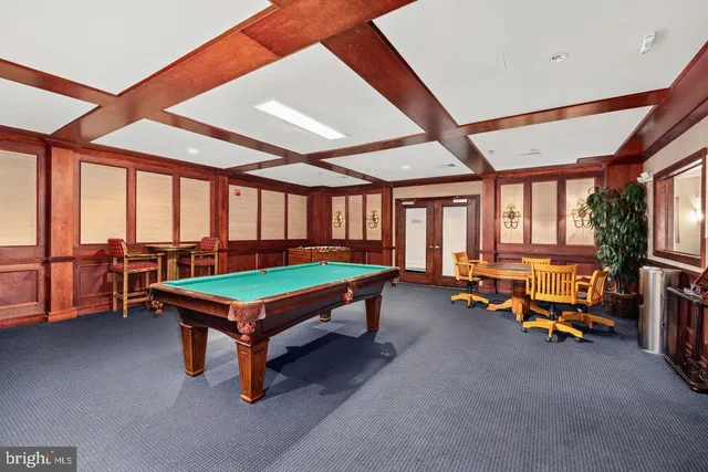 a room with pool table furniture and windows