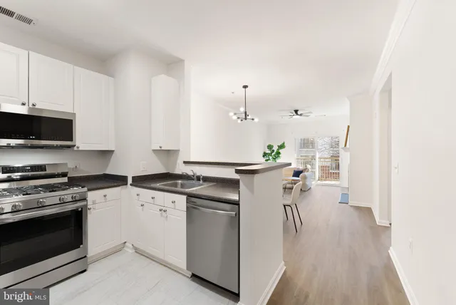 a kitchen with a stove a sink and a refrigerator