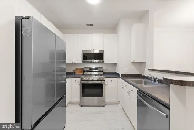 a kitchen with a sink stove and refrigerator