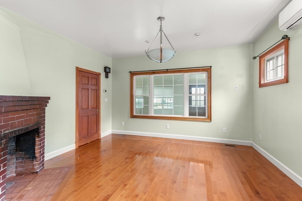 28 Stebbins Street Worcester, MA 01607 - Photo 11 of 29 a view of an empty room with wooden floor and a window